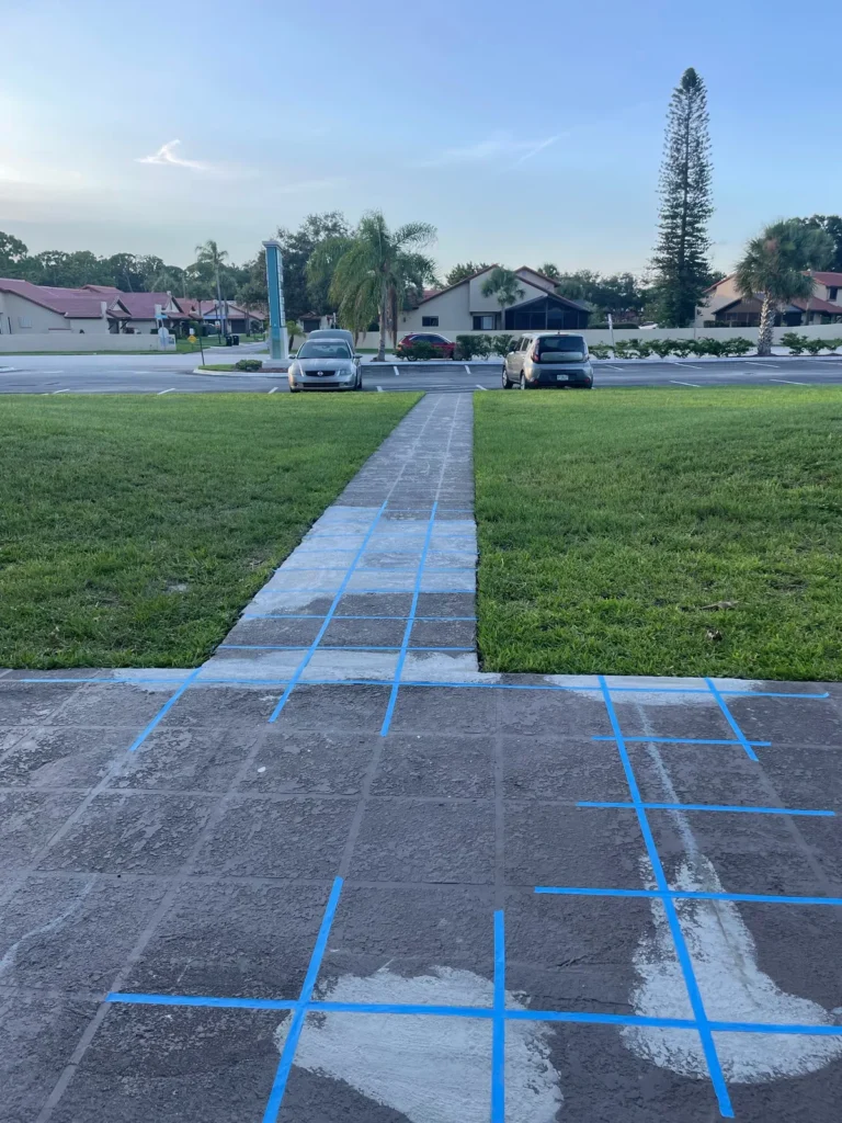 Concrete walkway taped and patched before decorative finish coat
