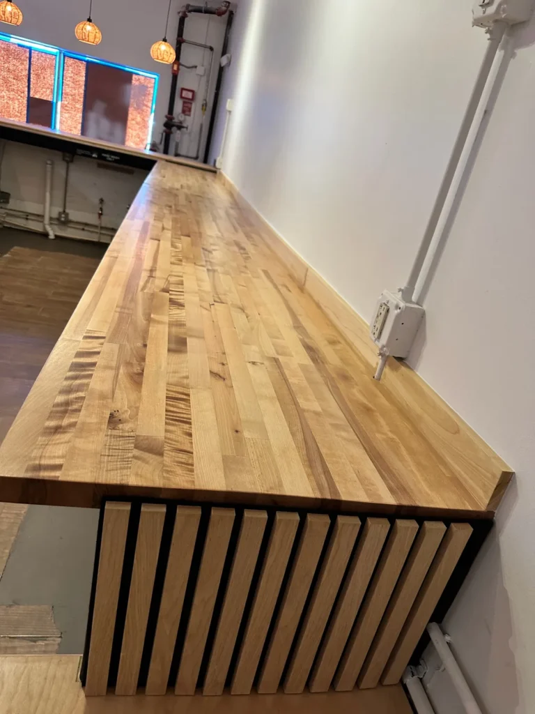 Custom butcher-block wood countertop with vertical wood slat accent